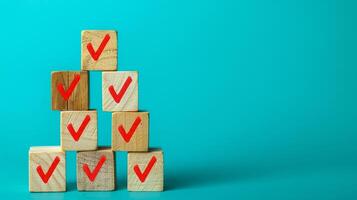 Check mark on wooden blocks with check mark on blue background photo