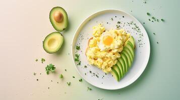 Scrambled eggs with avocado and parsley on a white plate photo