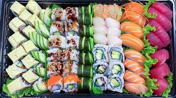 A tray of sushi with various types of food photo