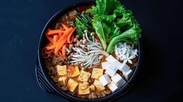 A bowl of food with meat, vegetables and tofu photo