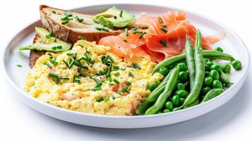 A plate of scrambled eggs, green beans, and toast photo