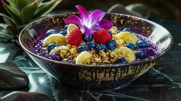 A bowl of fruit and a flower photo