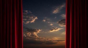 A red curtain is open to show the sky photo