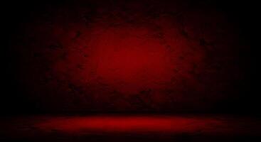 A dark red room with a red wall and a light photo