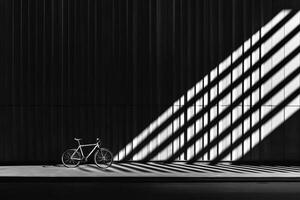 A bicycle is parked in front of a wall with shadows photo