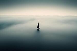 A sailboat is floating in the middle of the ocean photo
