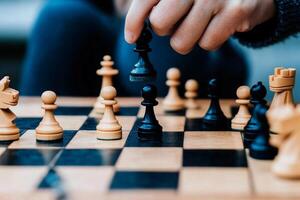 A person is playing chess on a board photo