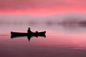 A man in a canoe paddling in the fog photo