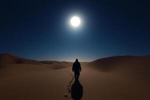 A man walking in the desert at night photo