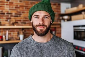 A man with a beard and a green beanie photo
