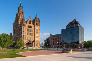 A large building with a clock tower in the middle of a city photo