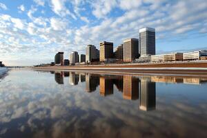 A city skyline reflected in a body of water photo