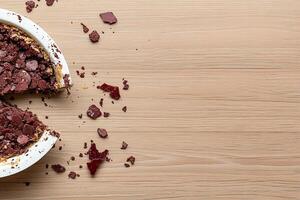 A pie with a piece missing on a table photo