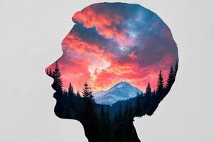 A double exposure of a person's head with a mountain in the background photo