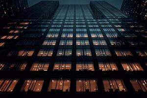 A tall building with windows lit up at night photo