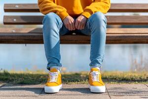 A person sitting on a bench with their legs crossed photo