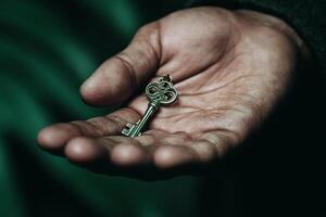 A person holding a key in their hand photo