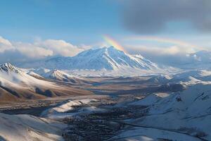 A rainbow is seen over a mountain range photo