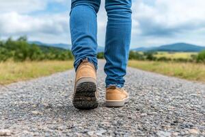 A person walking on a gravel road with their shoes on photo