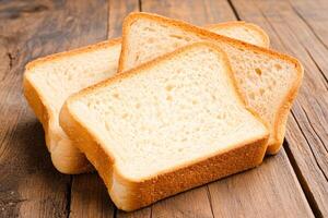 Three slices of white bread on a wooden table photo