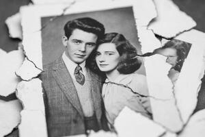 An old photo of a man and woman in front of a torn paper