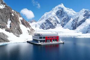 A red house sits on a small island surrounded by snow photo