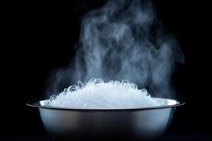 A bowl of ice is being heated in the dark photo