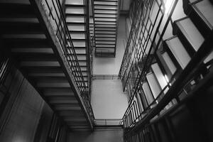 Black and white photograph of a stairway in a building photo