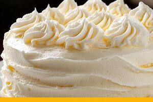 A white cake with frosting on top photo