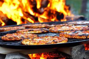 A grill with several pizzas cooking on it photo