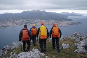 Four people with backpacks on a mountain overlooking a city photo