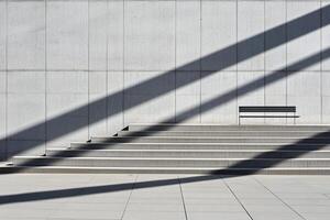 A bench is sitting on the steps of a building photo