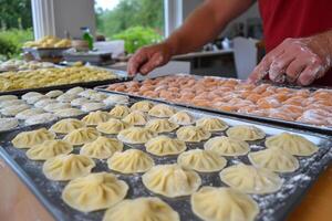 A man is preparing dumplings on a tray photo