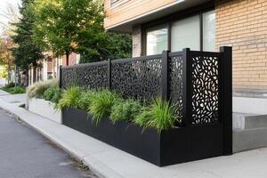 A black fence with plants in it photo