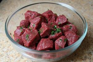 A bowl of raw beef with herbs in it photo