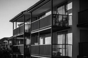 A black and white photo of a building with balconies