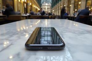 A black iphone sitting on a marble table photo