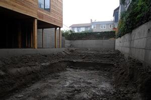 A large concrete pit in the middle of a yard photo