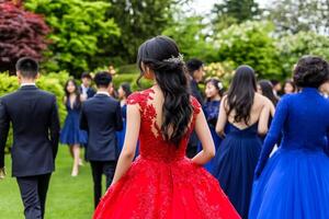 A woman in a red dress walking through a crowd of people photo
