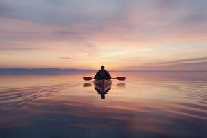 A person in a kayak at sunset photo