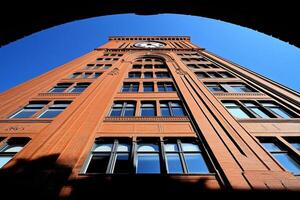 A tall building with a clock on the side photo