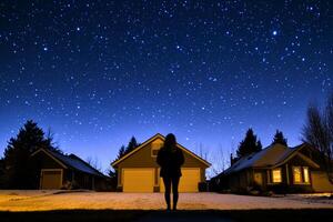 A woman standing in front of a house with stars in the sky photo