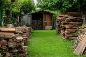A path with piles of wood stacked up in the yard photo