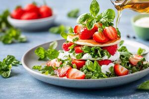 A plate with a stack of pancakes topped with strawberries and basil photo