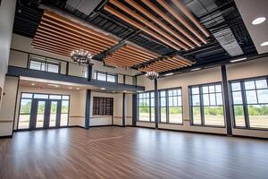 The interior of a large room with wood floors and windows photo