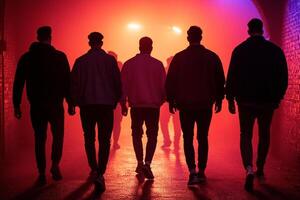 A group of men walking through a tunnel with red and blue lights photo