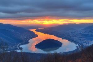 A view of a river and mountains at sunset photo