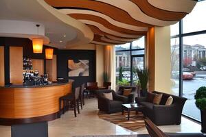 A modern bar with a curved wall and a large window photo