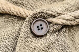 A button on a jacket with a rope photo