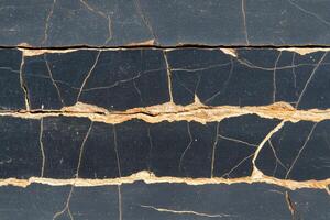 A close up of a cracked wall with a crack in it photo